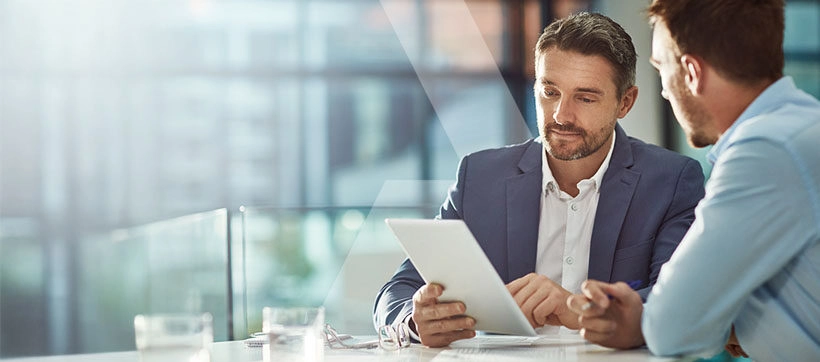 Two businessmen collaborating on CPQ to Revenue Cloud migration strategy