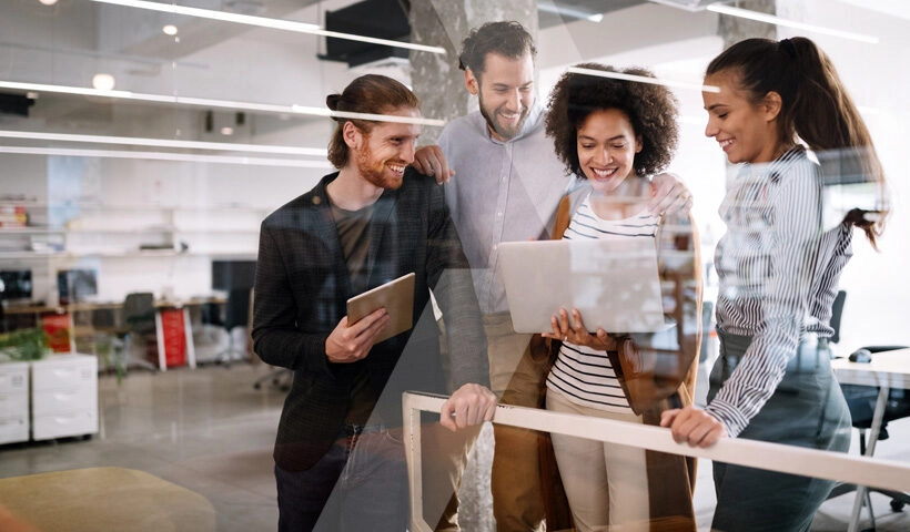 Four marketers collaborating on a campaign, representing how teams can plan their path to Marketing Cloud Next